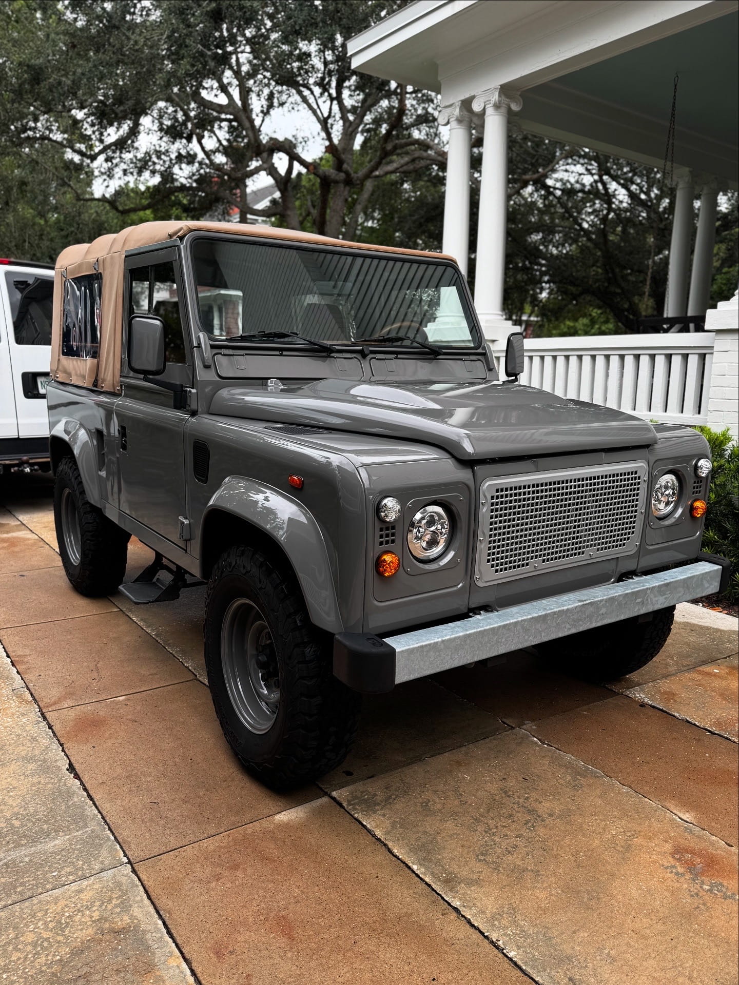Grey Land Rover Defender detailed in a Tampa Bay driveway