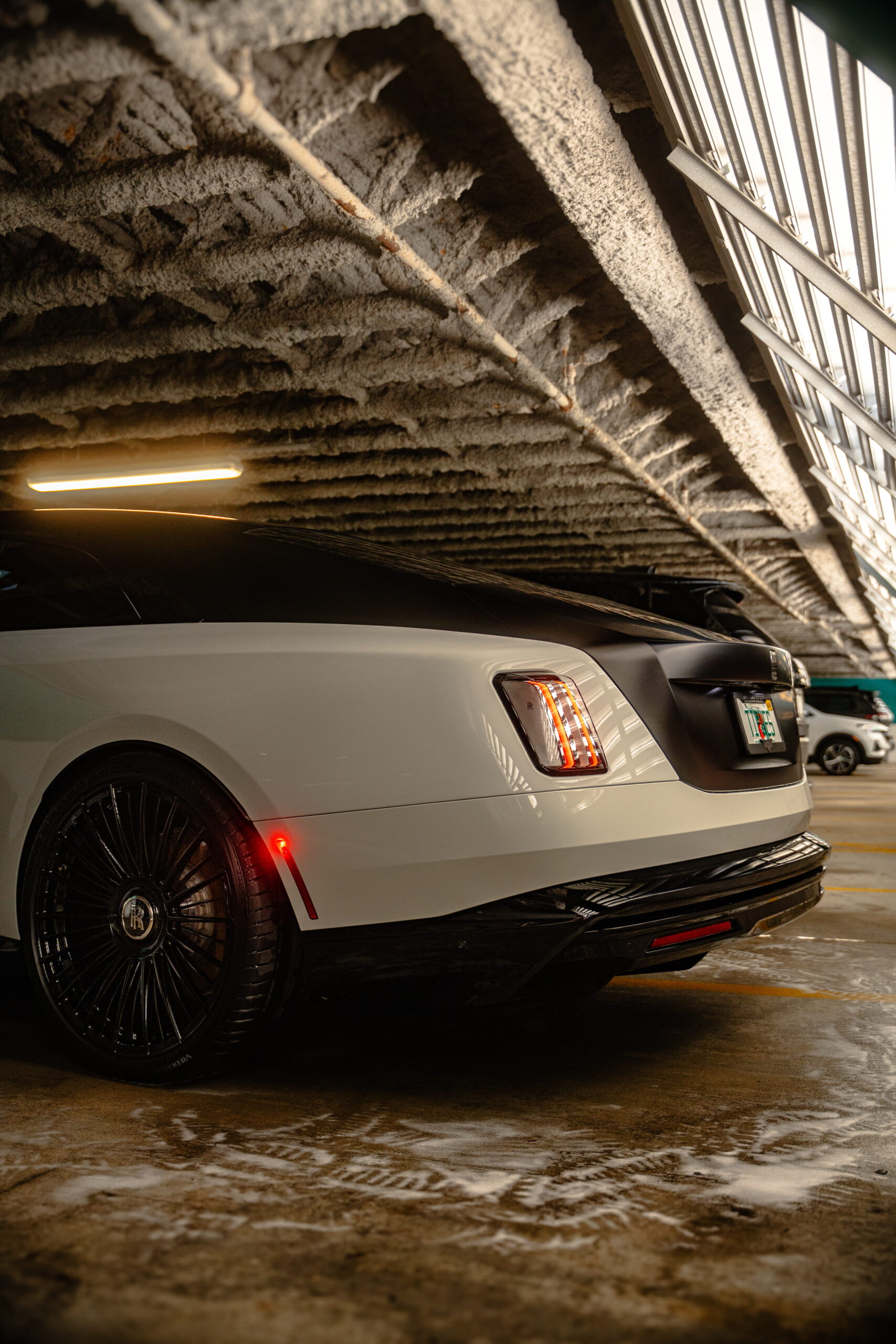 White Rolls-Royce Spectre after a mobile detail in a Tampa parking garage