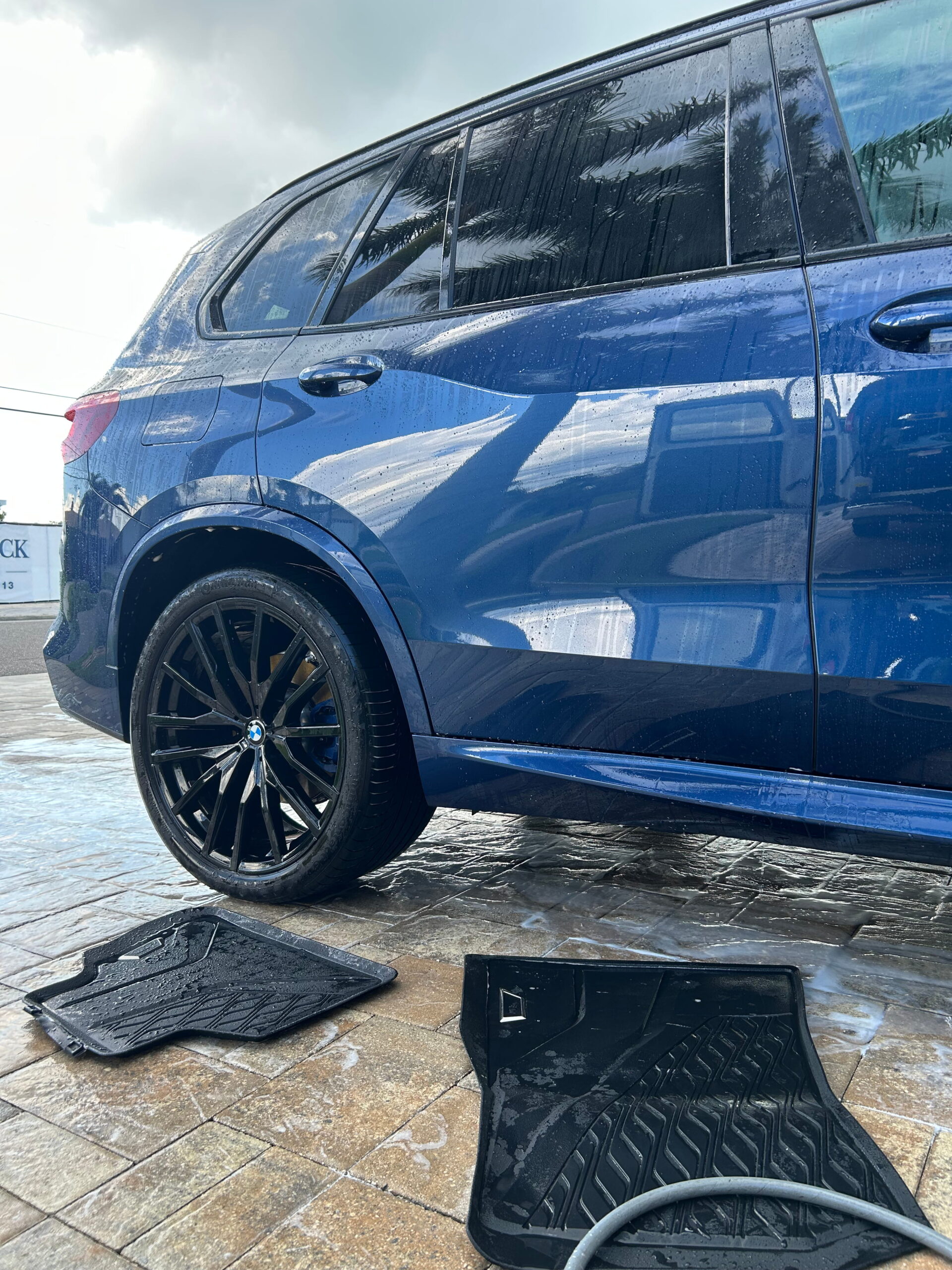 Blue BMW SUV during a mobile ceramic coating appointment in Tampa