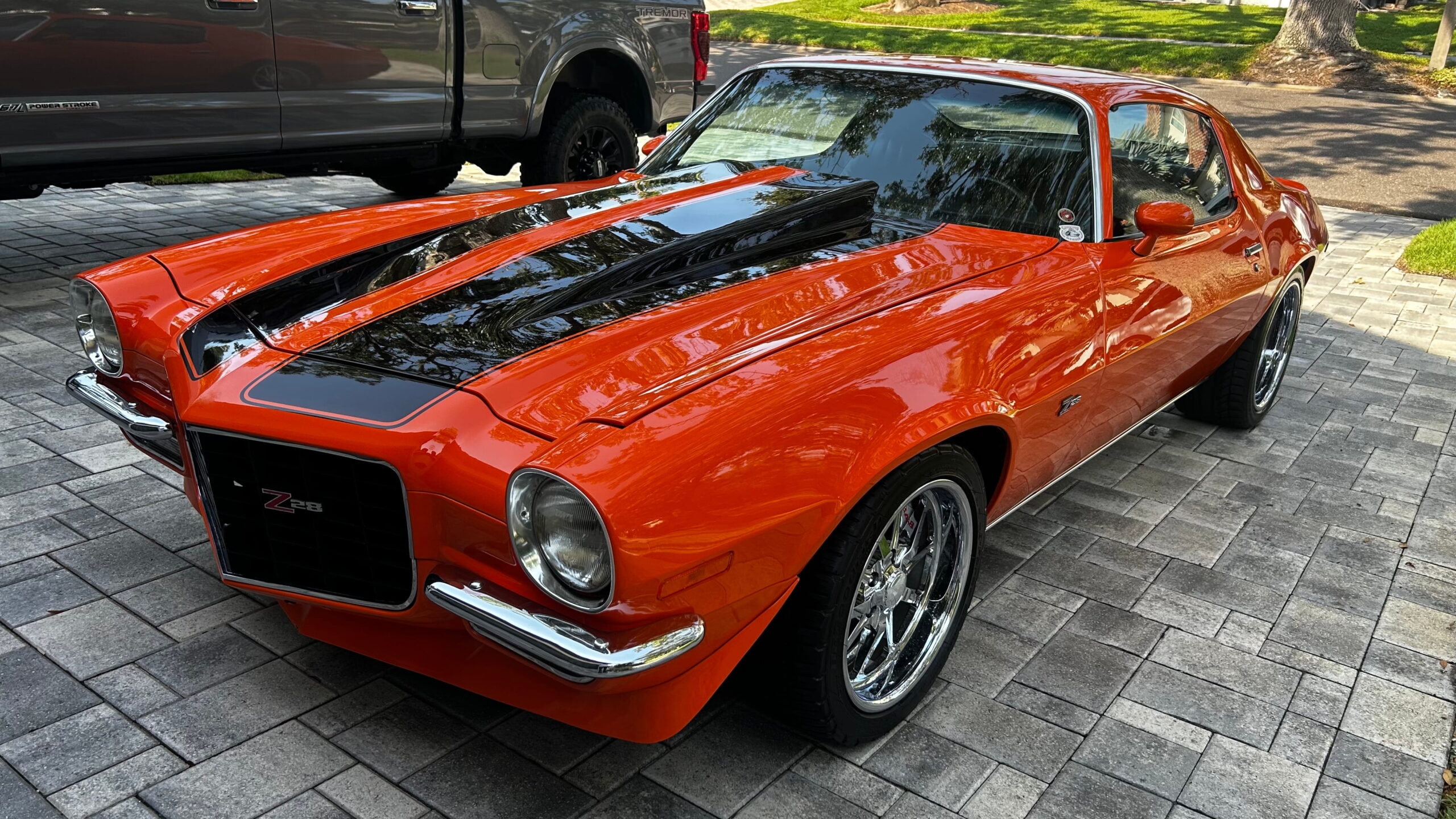 Orange classic Chevrolet Camaro detailed in a Tampa Bay driveway